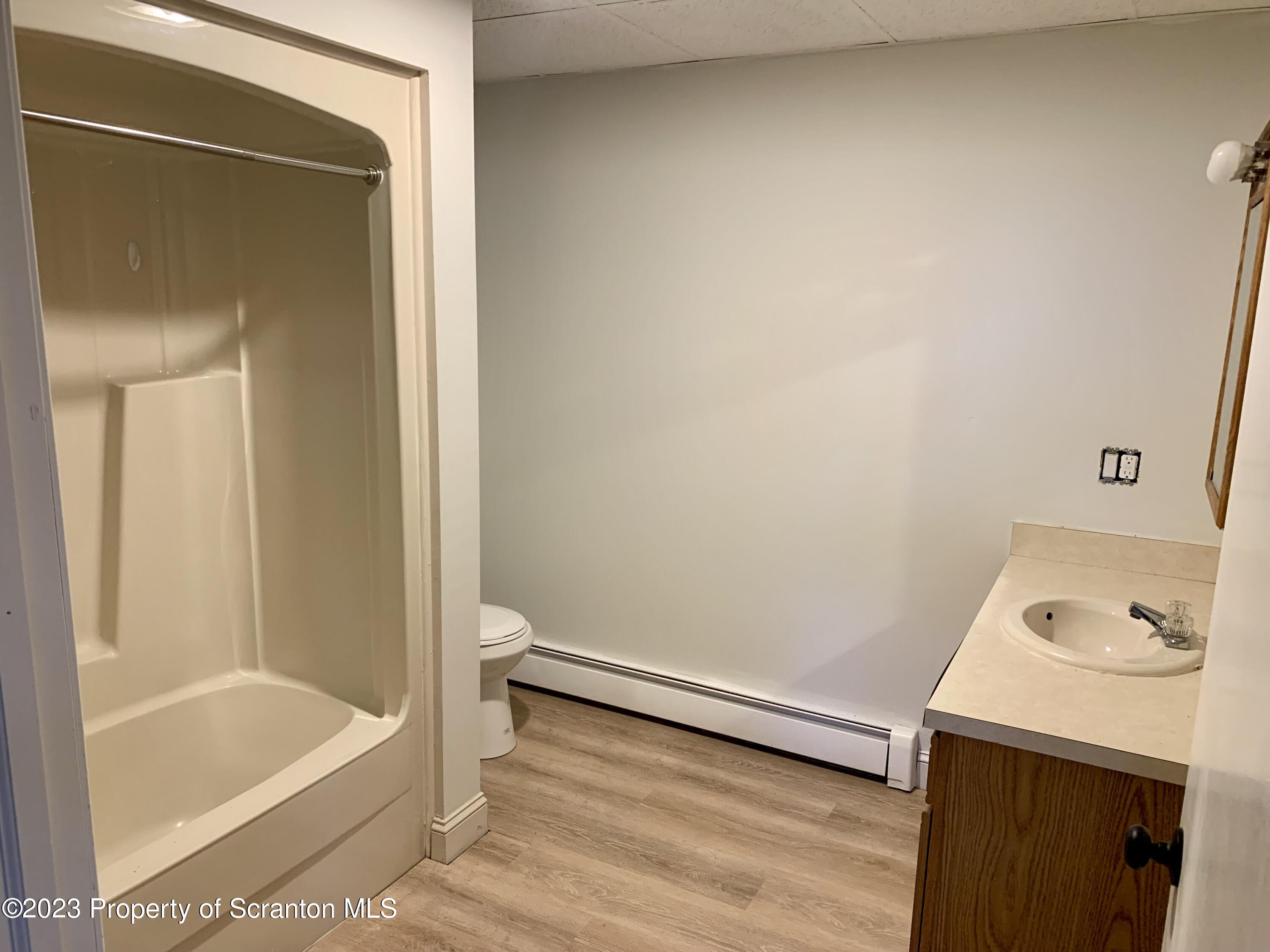 429 Smith Street, Unit B Dunmore, PA 18512 - Photo 6 of 6 a bathroom with a tub and a sink