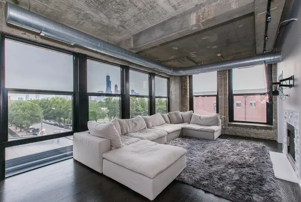 a living room with furniture tv and a large window