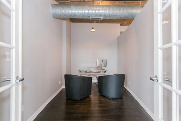 a room with a chair and wooden floor