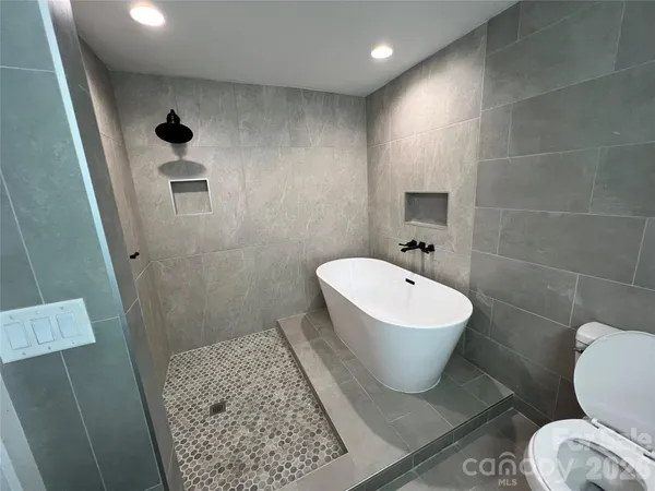 a white toilet sitting next to a bathroom sink and vanity