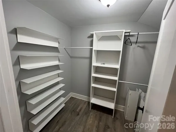 a view of walk in closet with empty racks