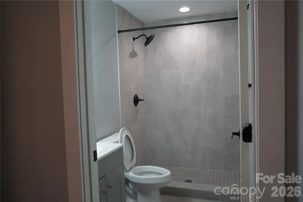 a bathroom with a toilet and a shower