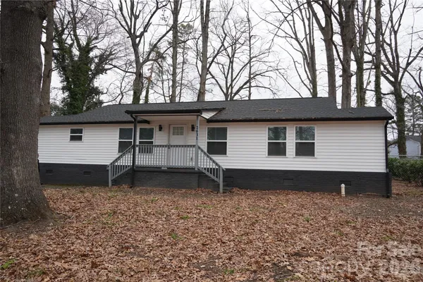 a house that has a tree in front of it