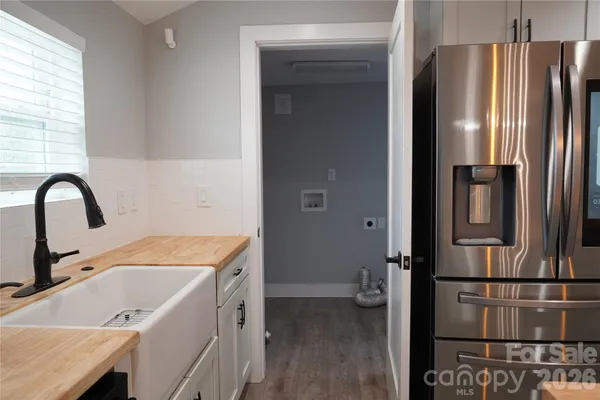 a kitchen with a refrigerator and a sink