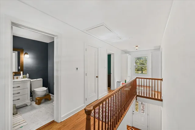 a view of a hallway to a livingroom and a livingroom with furniture