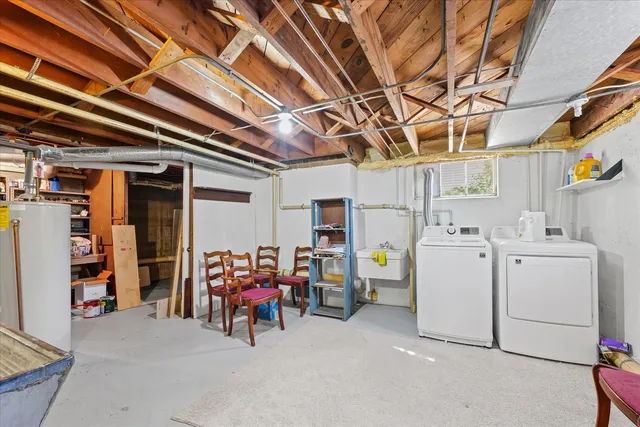 a view of storage and utility room with dryer and washer