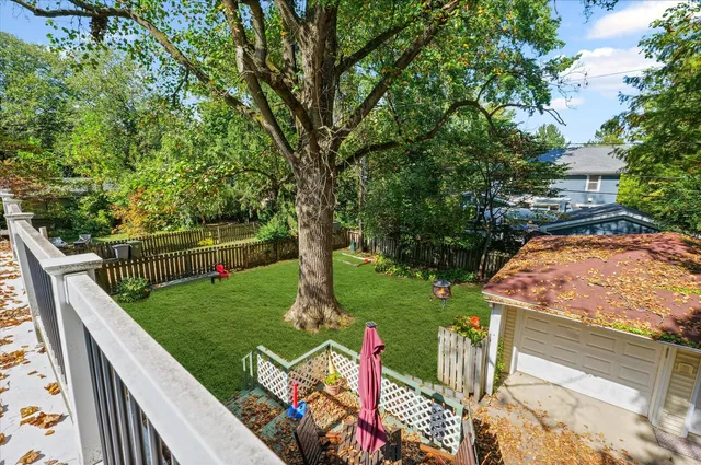 a view of a garden with wooden fence