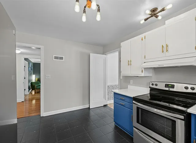 a kitchen with stainless steel appliances wooden cabinets and a stove top oven