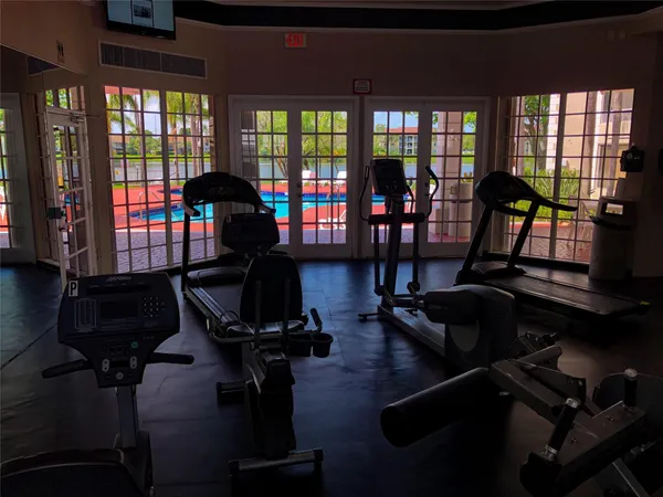 a room with gym equipment and windows