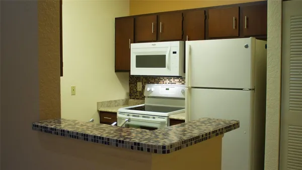 a kitchen with a sink and a refrigerator