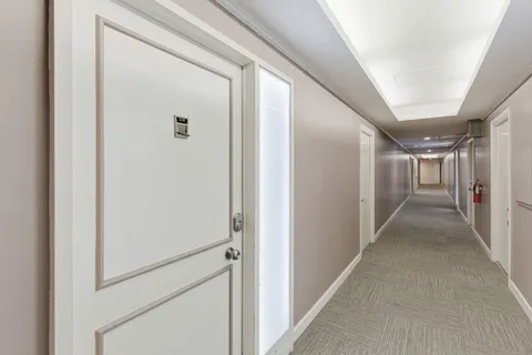 a living room with furniture and large window