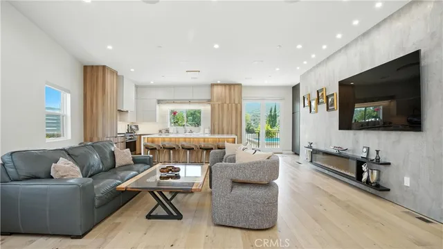 a view of a a dining room with furniture window and wooden floor