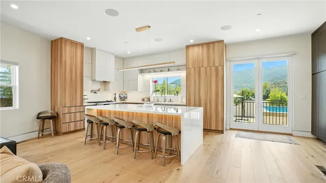 a kitchen with granite countertop a table chairs stove and cabinets