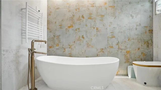 a bedroom with a bed and a mirror