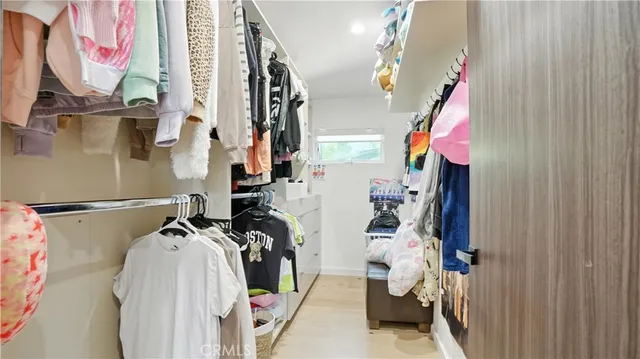 a bedroom with a large bed and a dresser