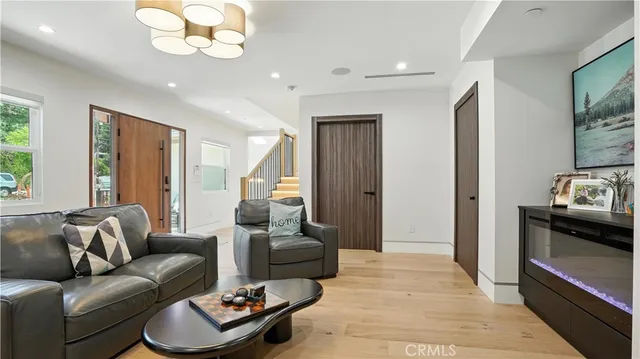 a view of a hallway with wooden floor and entryway