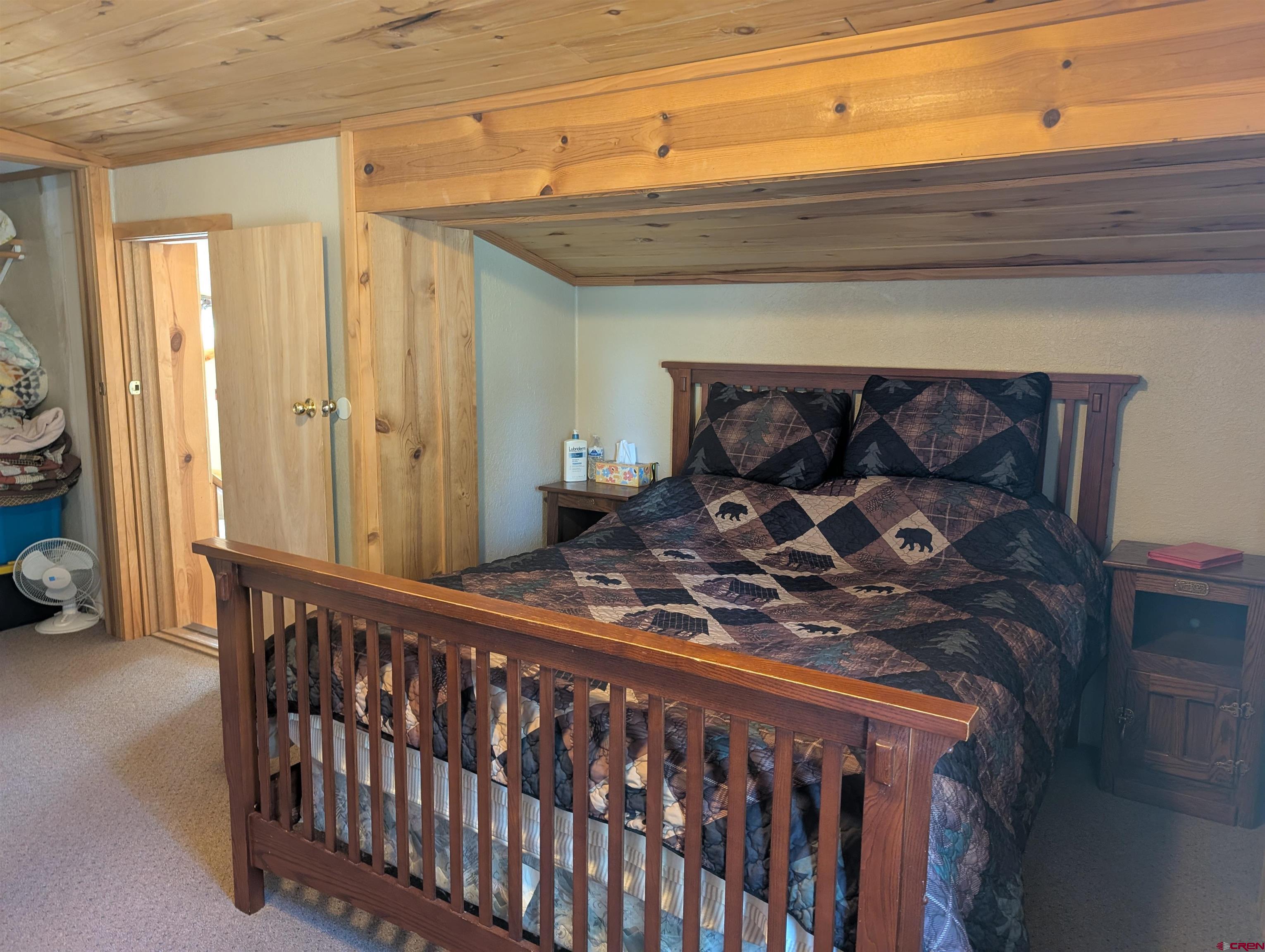 472 Haystack Circle Pagosa Springs, CO 81147 - Photo 21 of 34 a bed sitting in a bedroom next to a window