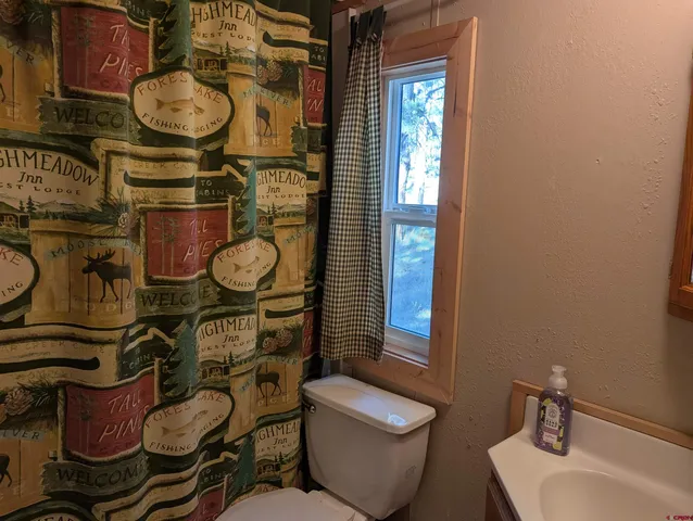 a bathroom with a toilet and a sink