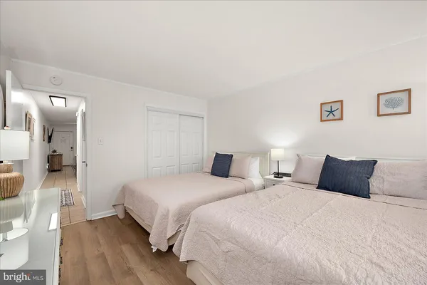a bedroom with two beds and a walk in closet