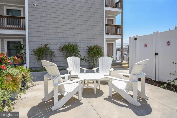 a view of a patio with chairs and potted plants