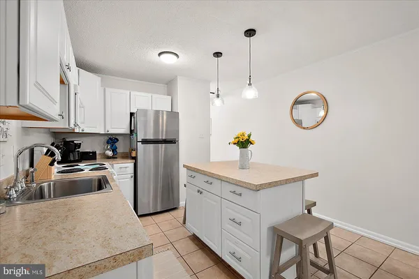 a kitchen with refrigerator cabinets and stove