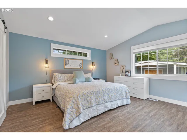 a bedroom with a large bed and a window