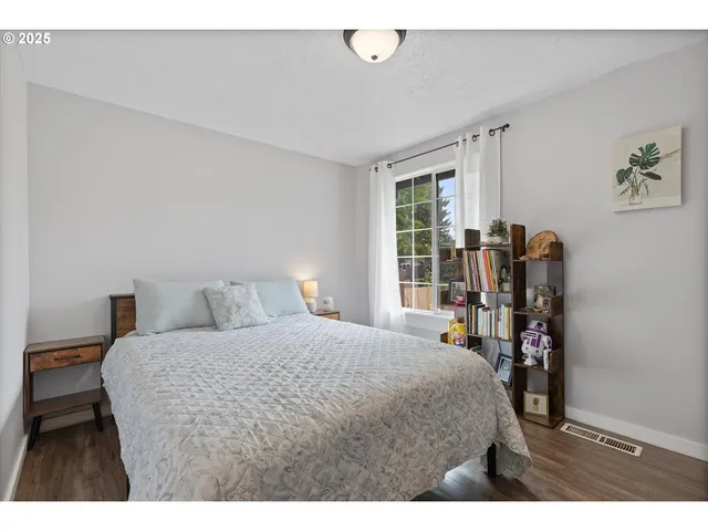 a bedroom with a bed garage and a window