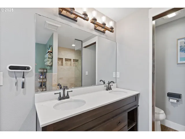 a bathroom with a sink vanity and mirror