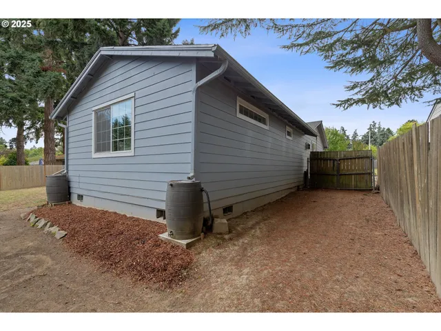 a view of backyard of house and car parked