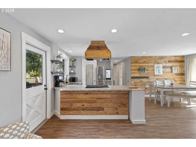 a view of living room with furniture and wooden floor