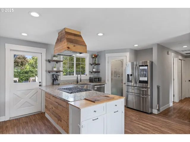 a kitchen with refrigerator and window