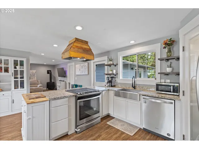 a kitchen that has a sink and stainless steel appliances