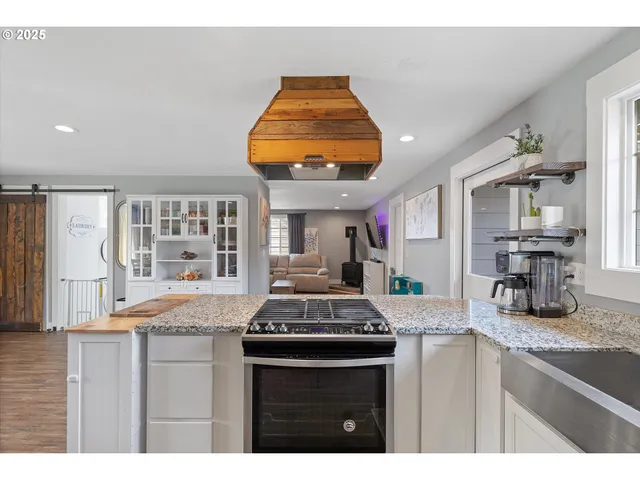 a kitchen with granite countertop a sink and a stove
