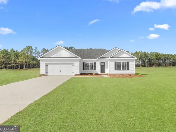 a kitchen with stainless steel appliances kitchen island granite countertop a dining table chairs and microwave