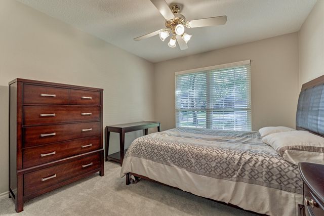 a bedroom with a bed dresser and a window