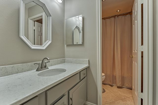 a bedroom with a bed dresser and a window