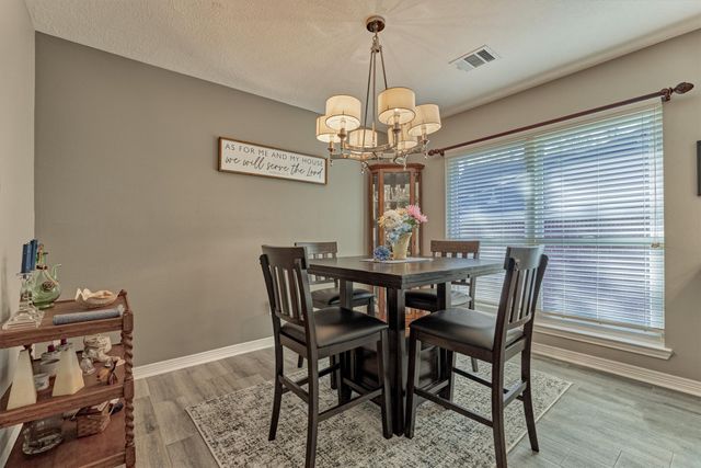 a kitchen with stainless steel appliances granite countertop a sink a stove and a wooden floors
