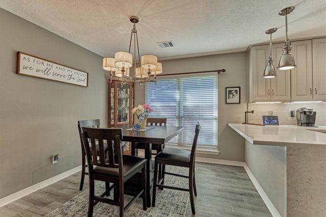 a kitchen with stainless steel appliances granite countertop a sink refrigerator and cabinets