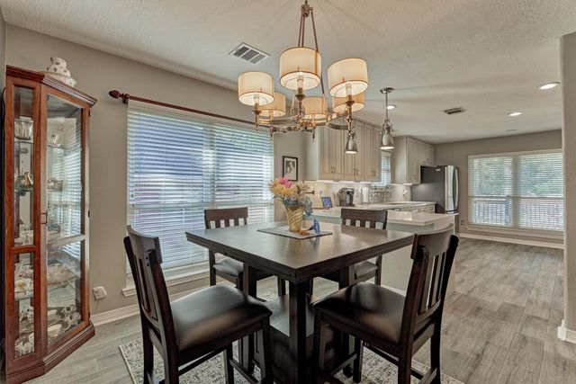 a kitchen with a sink stove and refrigerator
