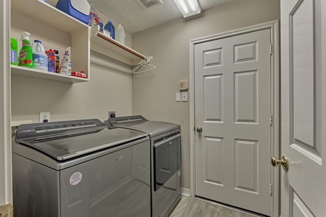 a view of deck with a large window and wooden floor