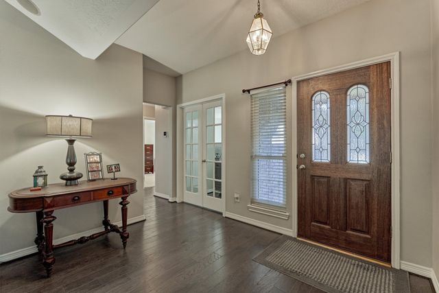 a kitchen that has a stove and a wooden floor