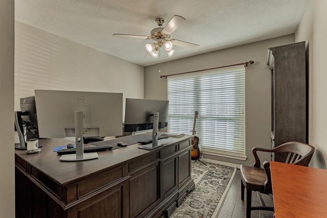 a en suite bathroom with a granite countertop sink and a mirror