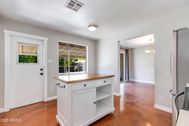 a view of a kitchen with wooden floor and outdoor space