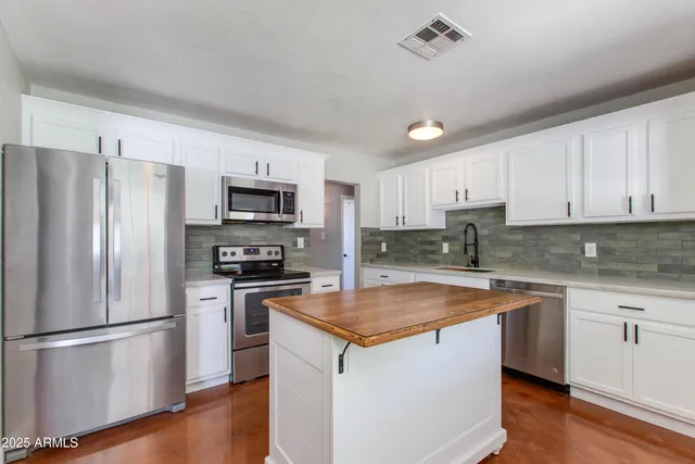 a kitchen with a refrigerator stove and microwave
