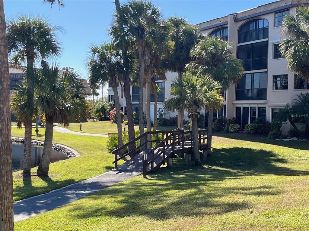 23465 Harbor View Road, Unit 1006 Punta Gorda, FL 33980 - Photo 29 of 41 a view of swimming pool with lawn chairs and plants