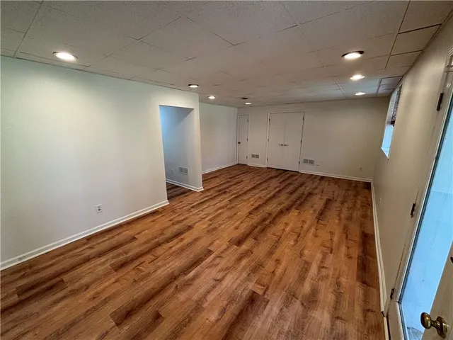 an empty room with wooden floor