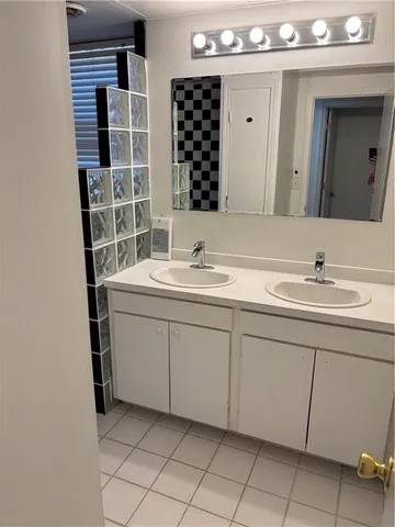 a bathroom with a sink vanity and a mirror