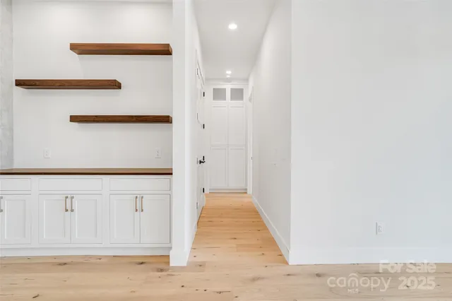 a view of a hallway with wooden floor