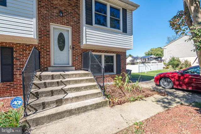 a view of a house with a yard and sitting area