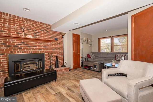 a living room with fireplace furniture and a flat screen tv